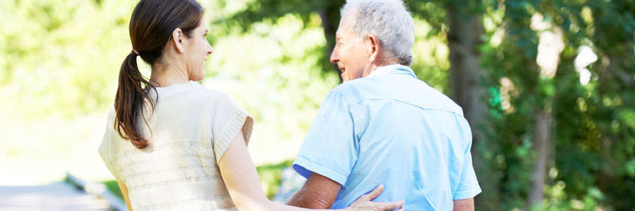 Daughter walking with elderly father